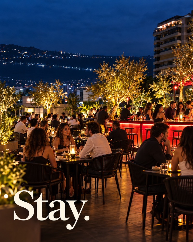 AI-created FRIDA campaign image showing a busy rooftop, illuminated olive trees and Jounieh Bay